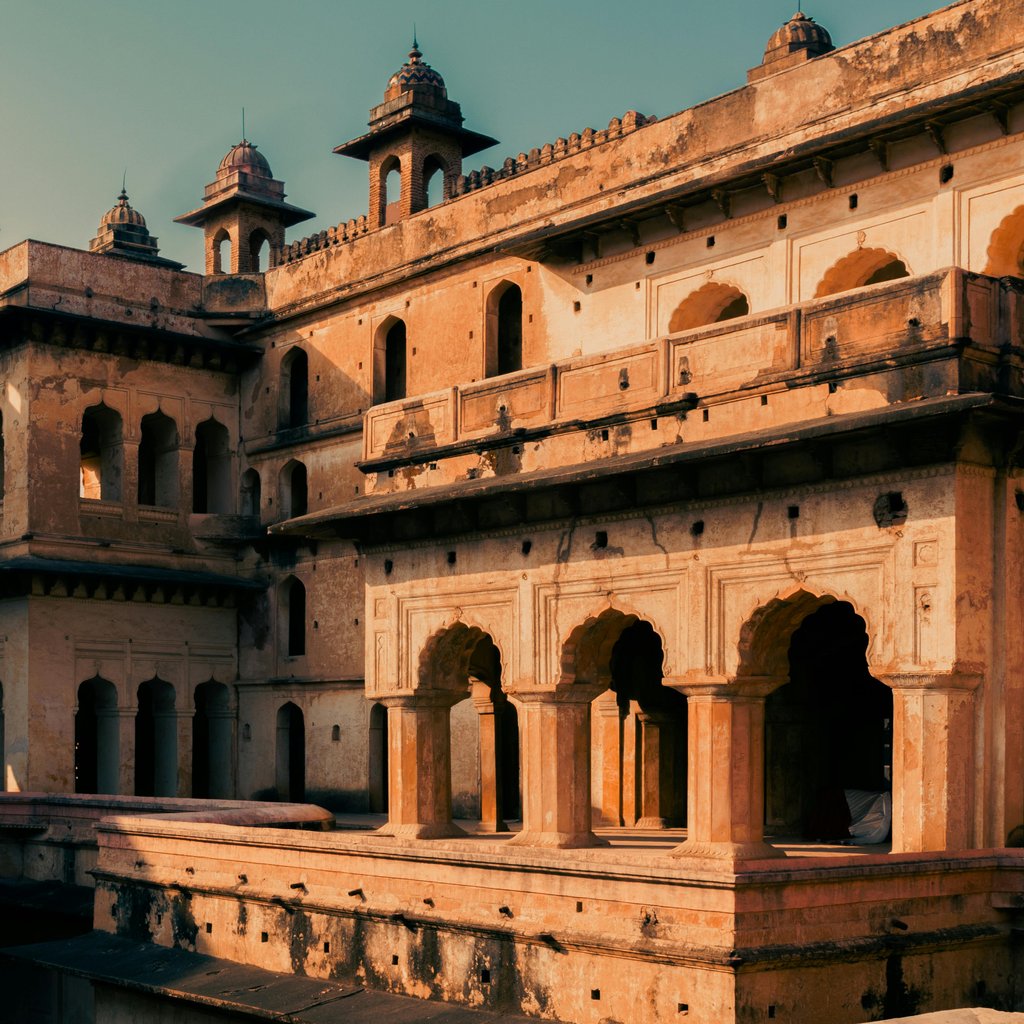 Capture of the iconic Raja Mahal showcasing Rajput architecture in Orchha, India at sunset.