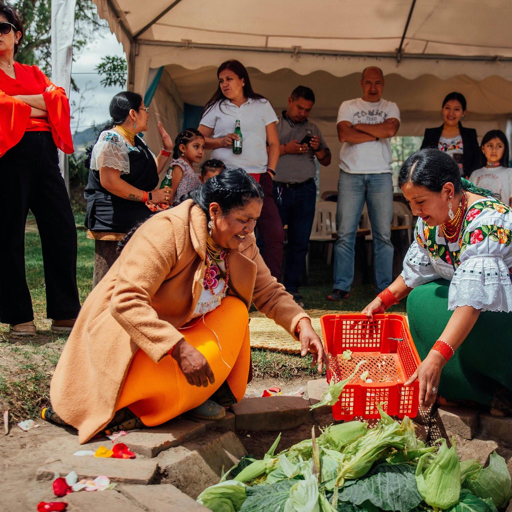Women in traditional clothing participating in a cultural gathering in Otavalo, Ecuador.