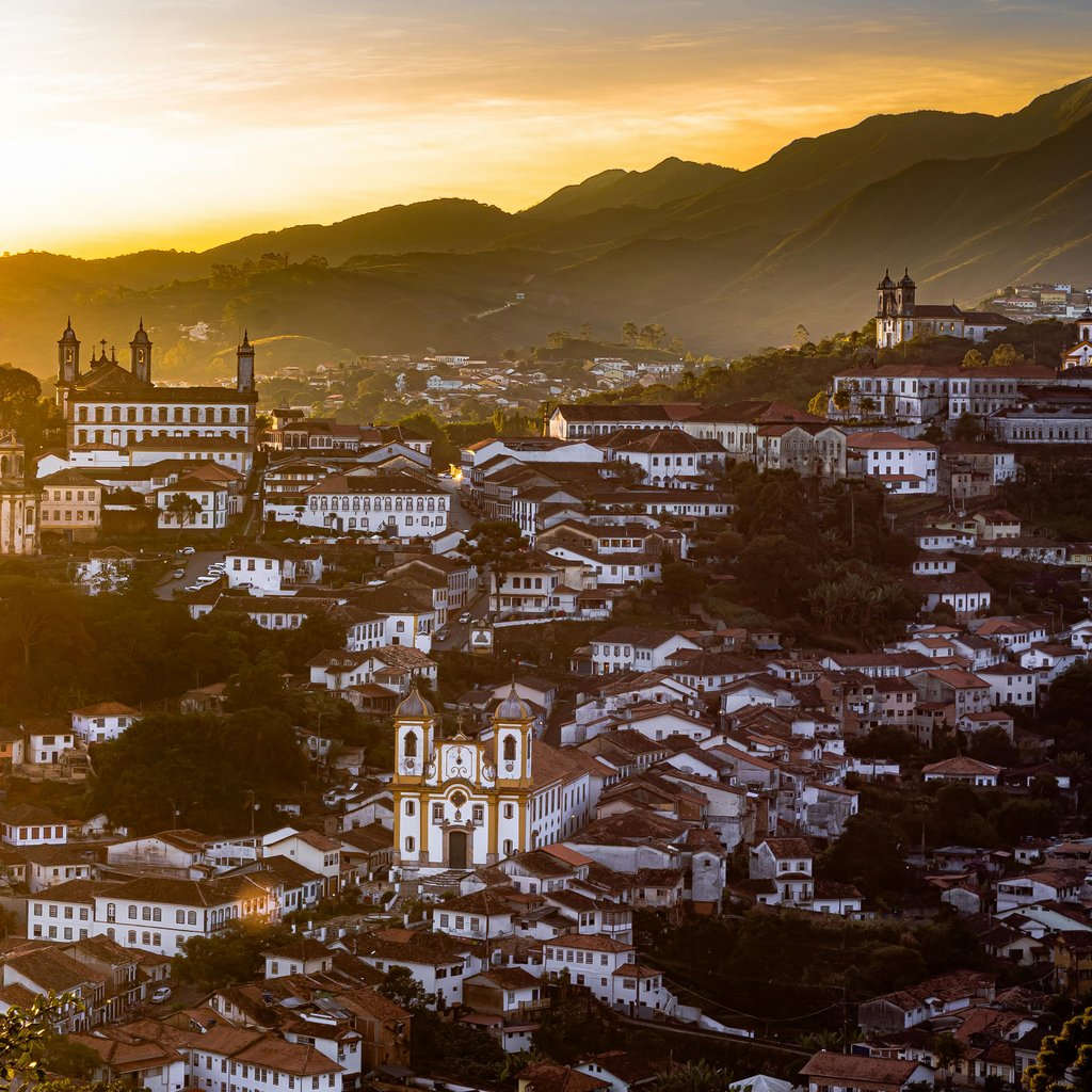 A breathtaking sunset view of Ouro Preto, Brazil showcasing historic colonial architecture.