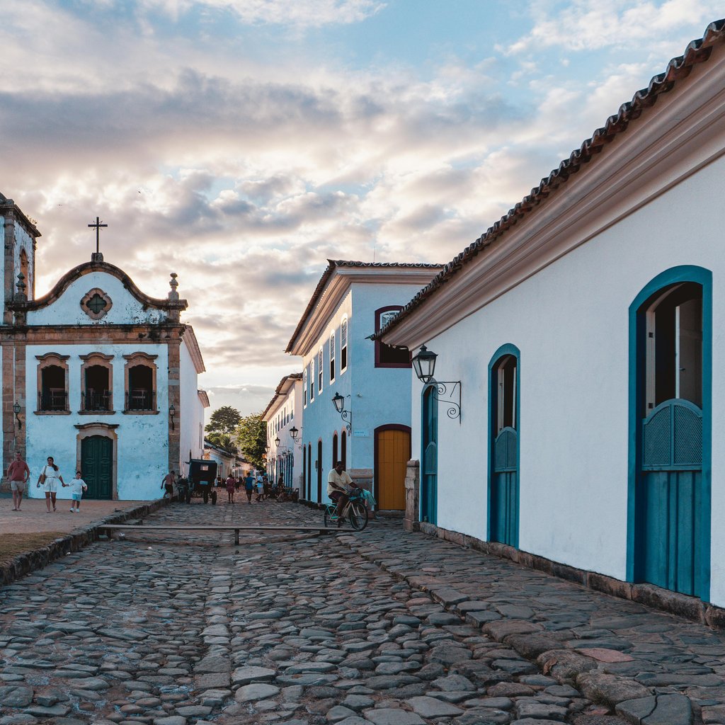 Scenic view of a historic church and colonial architecture in Paraty, Brazil during sunset.