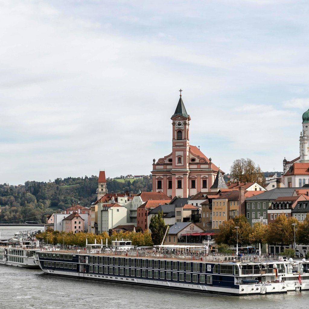 Panoramic view of Passau's old town and churches along the Danube River.