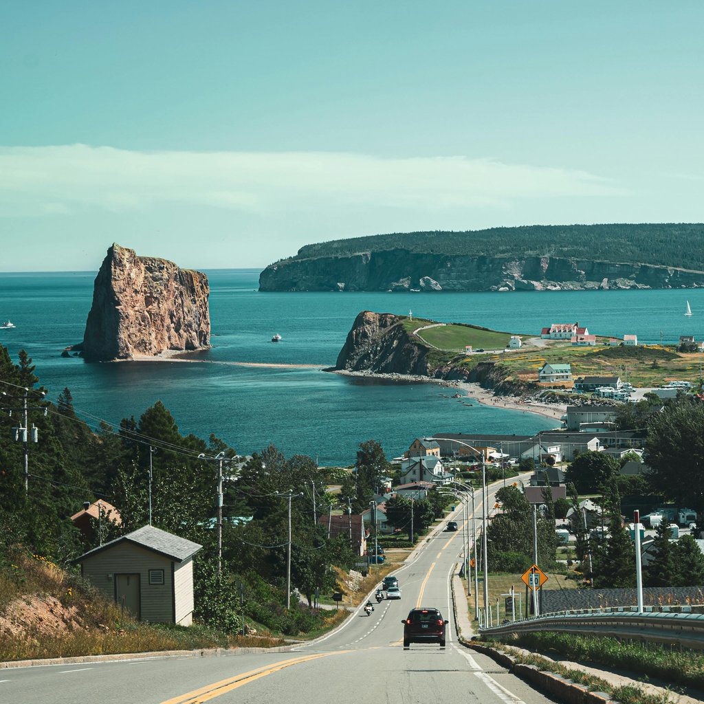 Beautiful coastal view of Percé Rock and the village in Quebec, Canada during the daytime.