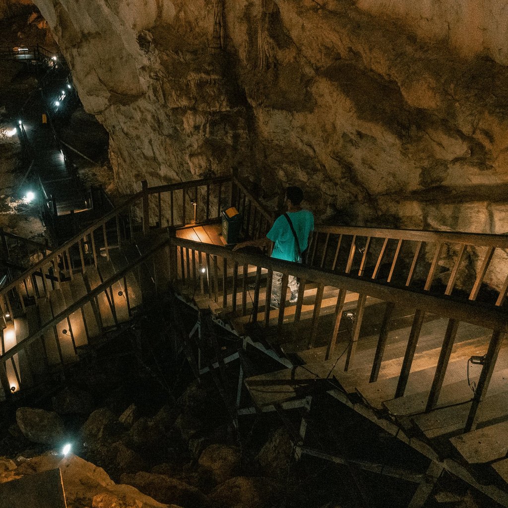 Discover the enthralling beauty of Paradise Cave with illuminated stairs and rocky interiors.