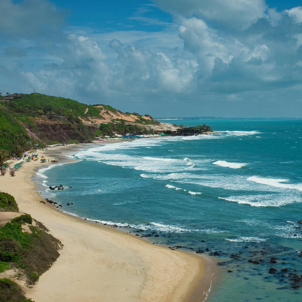 Beautiful aerial view of Pipa Beach with turquoise waves along the Brazilian coast.