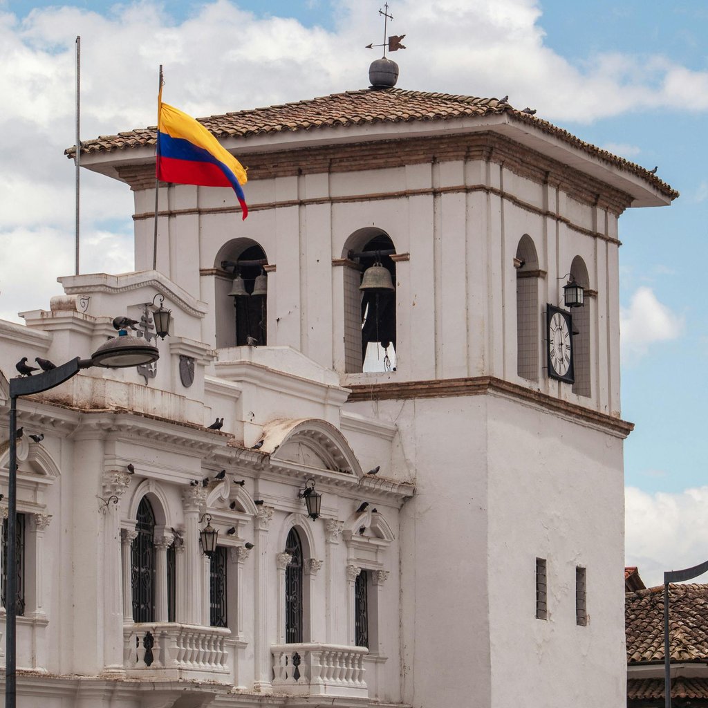 Stunning view of the iconic clock tower with Colombian flag in Popayán, Cauca.