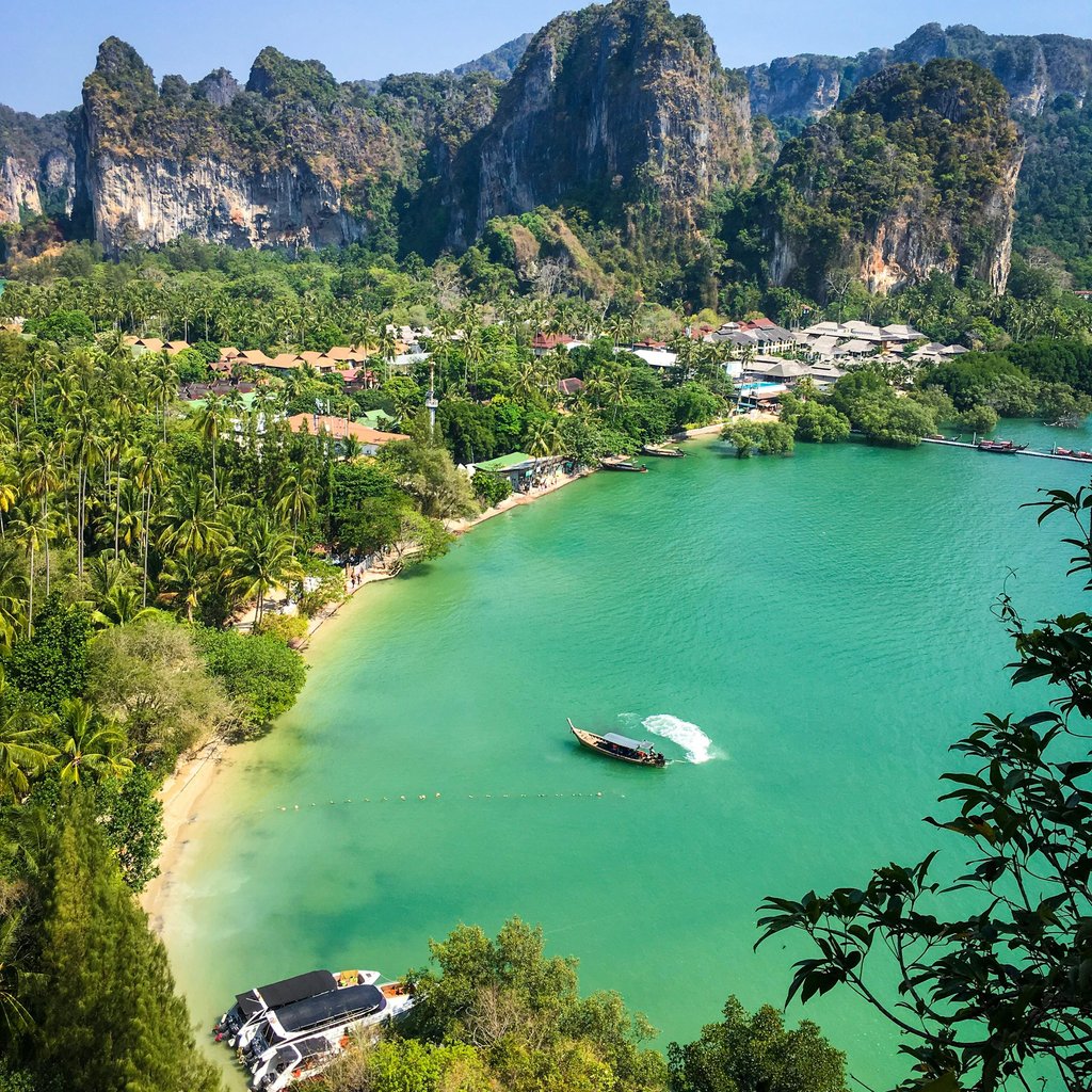 Explore the breathtaking emerald waters and lush landscapes of Railay Beach in Krabi, Thailand.
