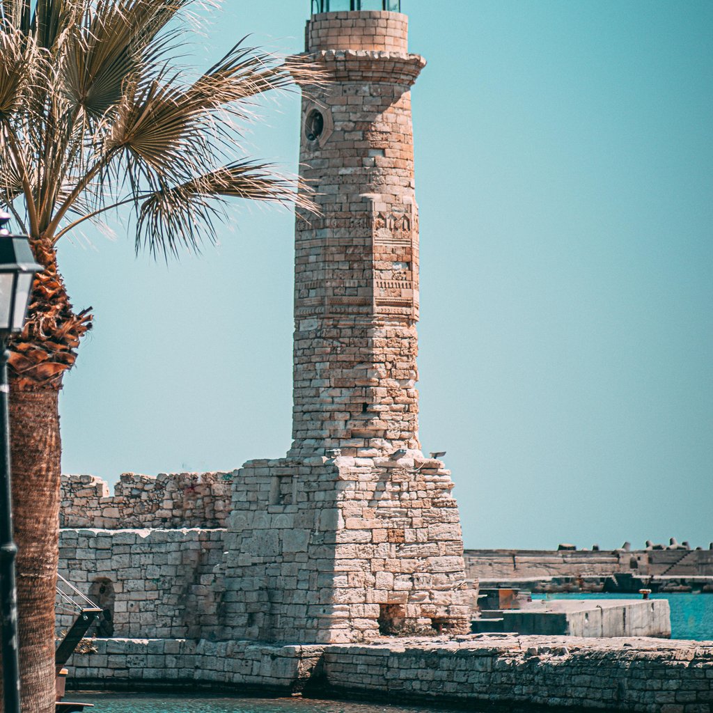 Explore the iconic Venetian lighthouse in Rethimno, Crete, a beautiful example of Ottoman architecture by the sea.