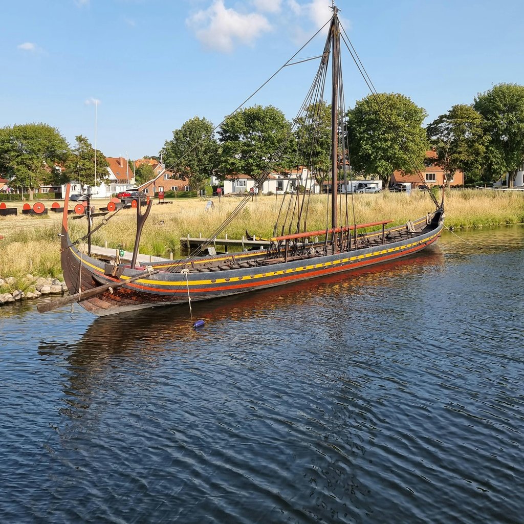 Historic Viking ship moored on a bright day in Roskilde, Denmark.