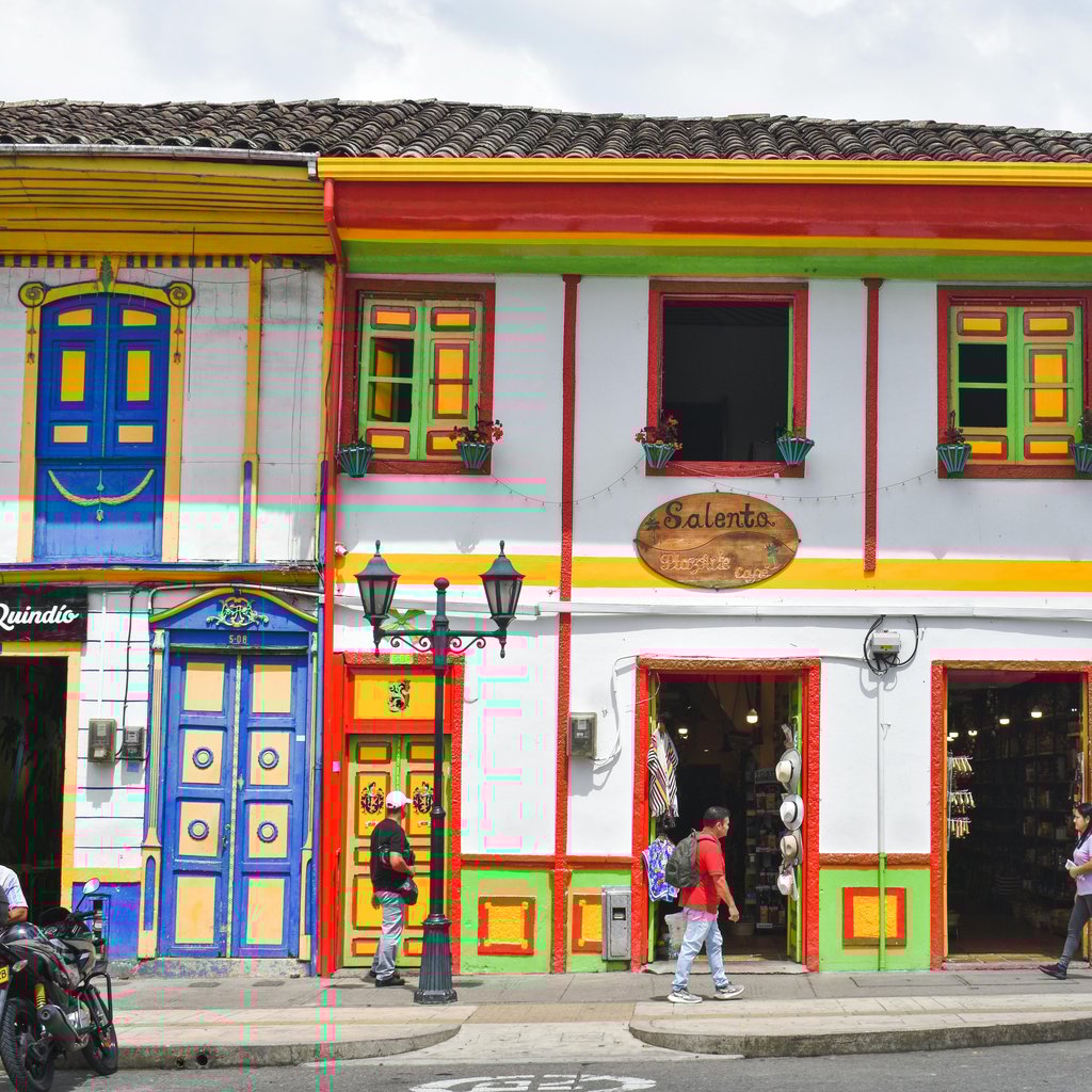 Vibrant colonial architecture on a bustling street in Salento, Colombia.