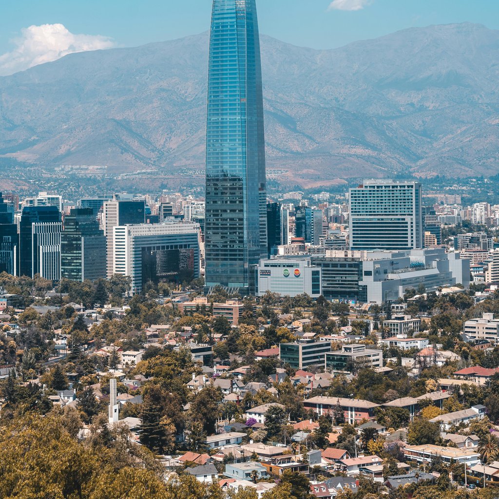 Aerial view of Santiago featuring the Costanera Center and mountain backdrop.