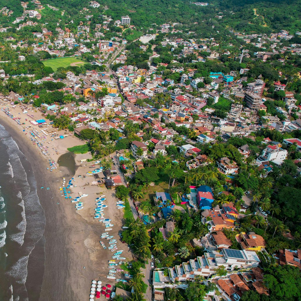 Discover the stunning coastline of Sayulita, Mexico from above with its vibrant town and turquoise waters.