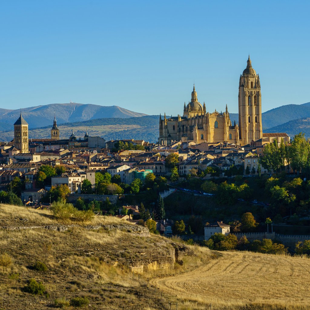 Panoramic view of Segovia featuring its majestic cathedral and medieval architecture under a clear blue sky.
