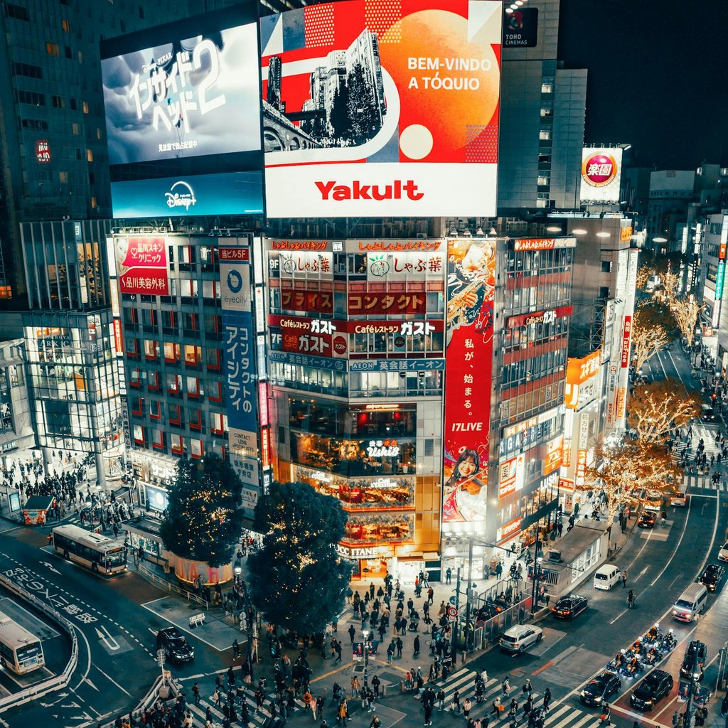 A bustling night scene of Shibuya Crossing, Tokyo, with vibrant city lights and crowds.