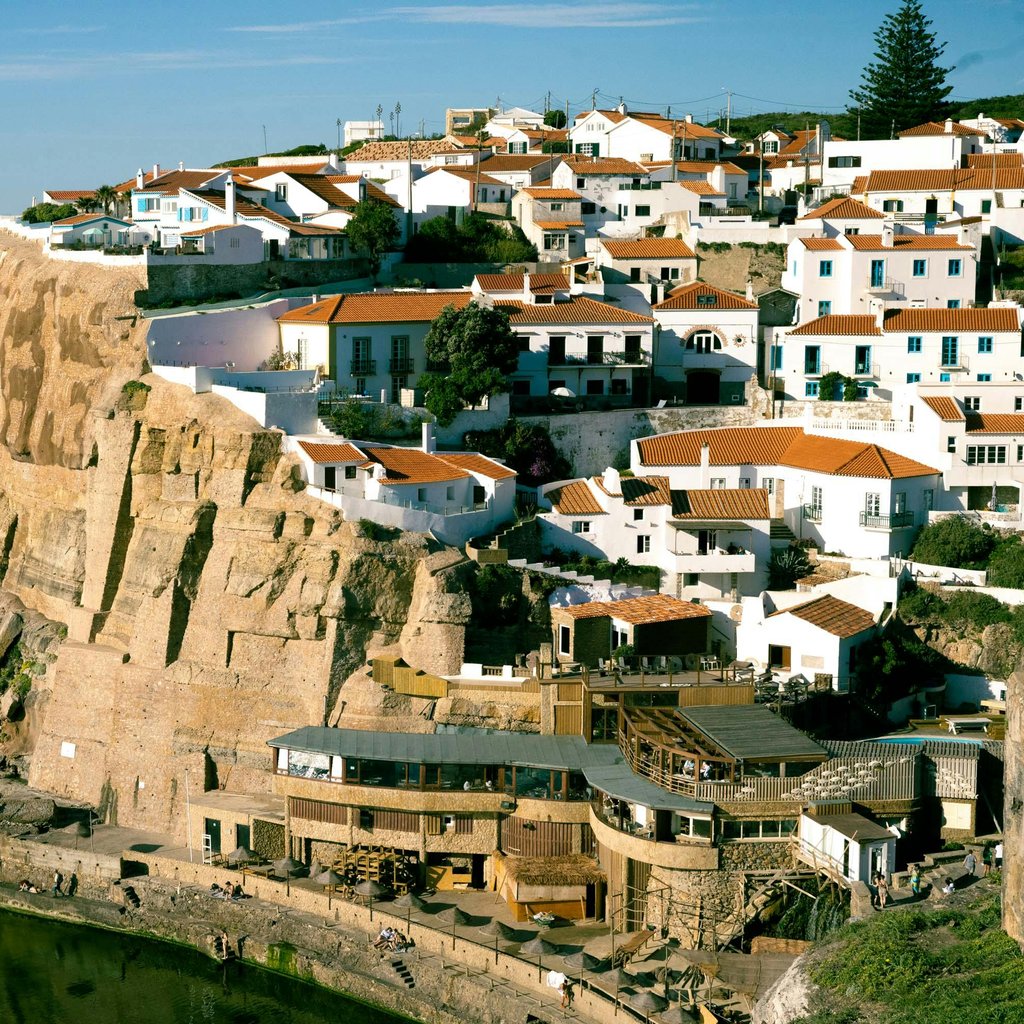 Explore the stunning landscape of Sintra, Portugal with this breathtaking aerial view of its cliffside town.
