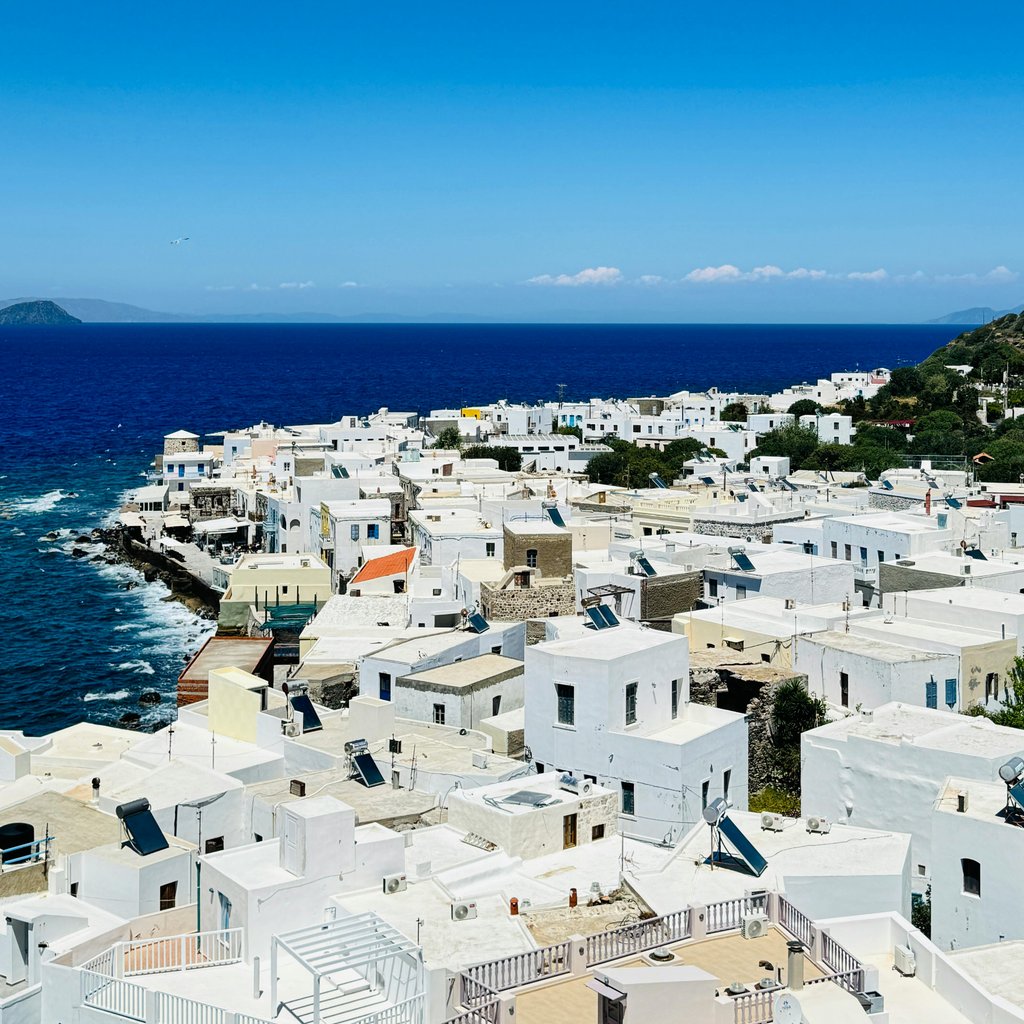 Breathtaking view of white Greek houses and the deep blue Aegean Sea on Symi Island.