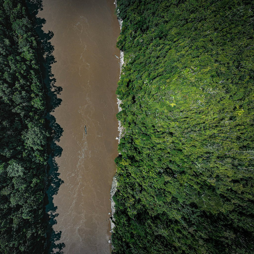 A stunning aerial view of a river cutting through dense rainforest in Tarapoto, Peru.