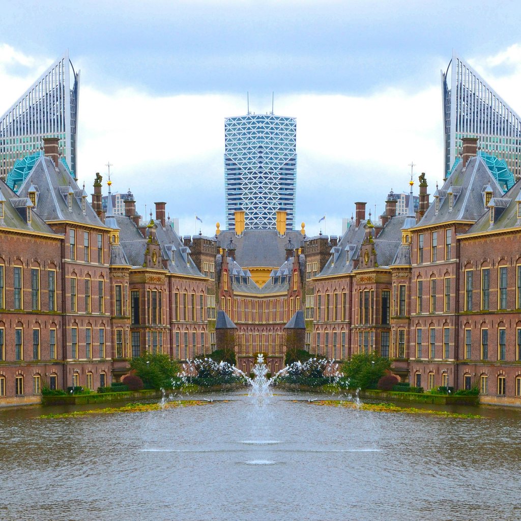 A stunning view of the Binnenhof with the modern skyline of The Hague, Netherlands.