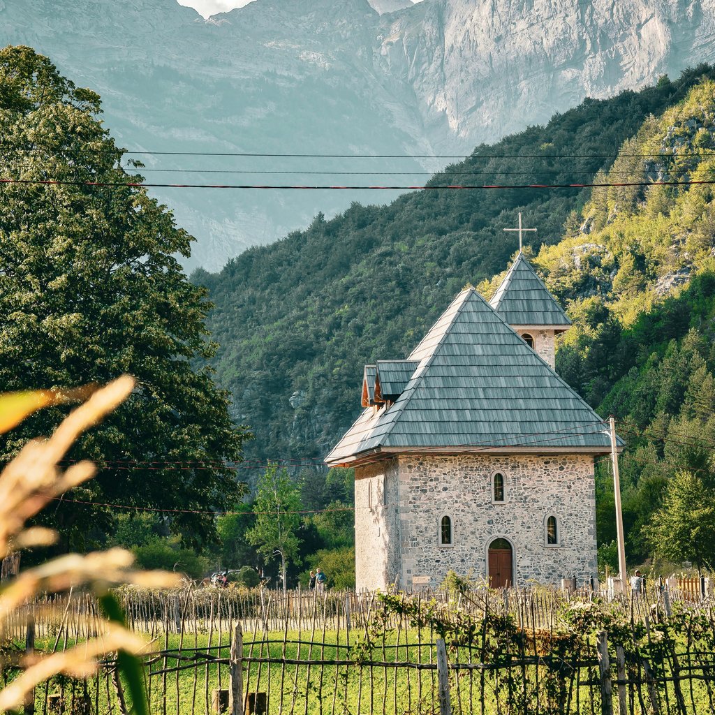 Discover a quaint chapel nestled in the picturesque Theth Valley, surrounded by majestic Albanian mountains.