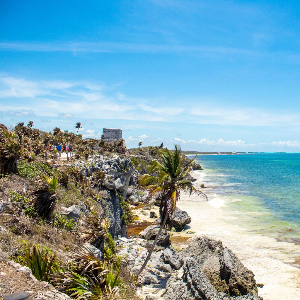Stunning beach view at Tulum, Mexico featuring turquoise waters and ancient ruins.