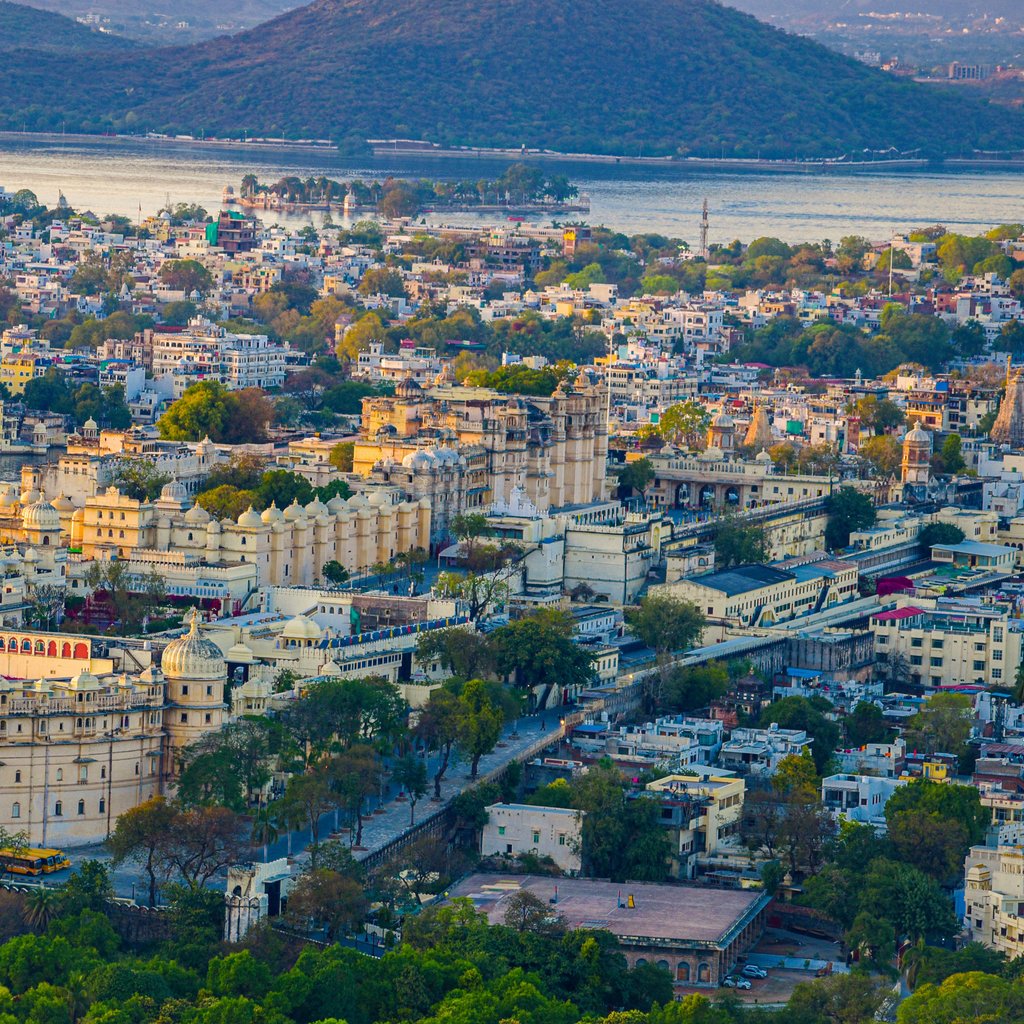 Stunning aerial view of Udaipur City and City Palace featuring scenic landscapes and vibrant architecture.