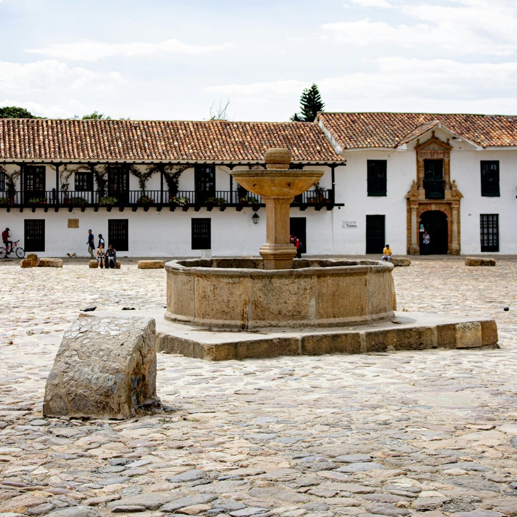 Explore the historic charm of Villa de Leyva's main plaza, featuring colonial architecture and a central stone fountain.
