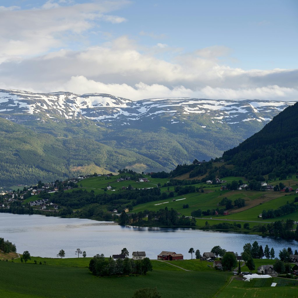Breathtaking view of snow-capped mountains and lush valleys in Voss, Norway.