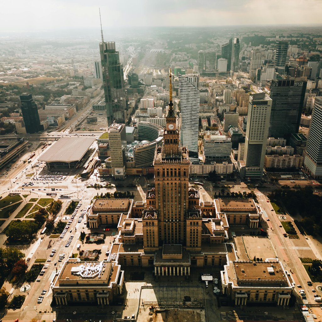 Stunning aerial shot of Warsaw featuring the Palace of Culture and Science amid modern skyscrapers.