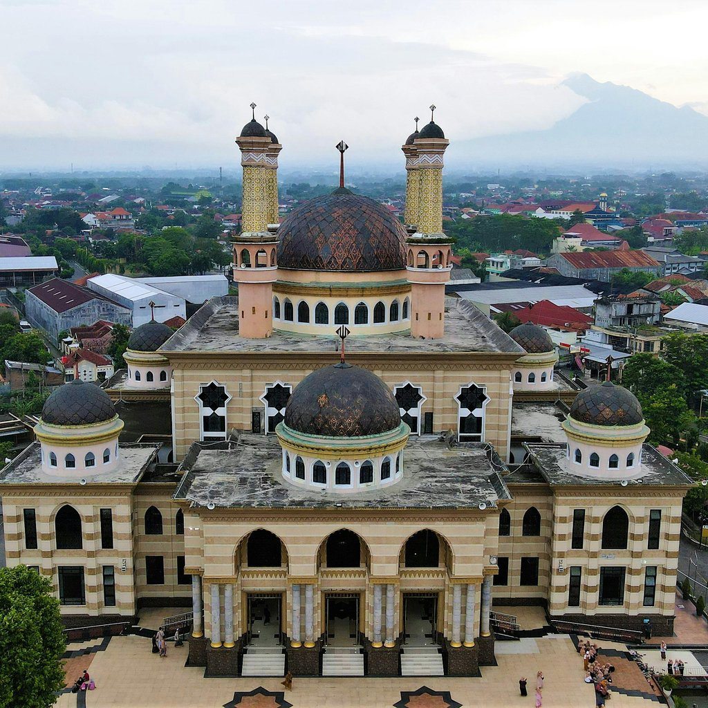 Stunning aerial shot of Masjid Agung, Yogyakarta amid lush greenery and urban landscape