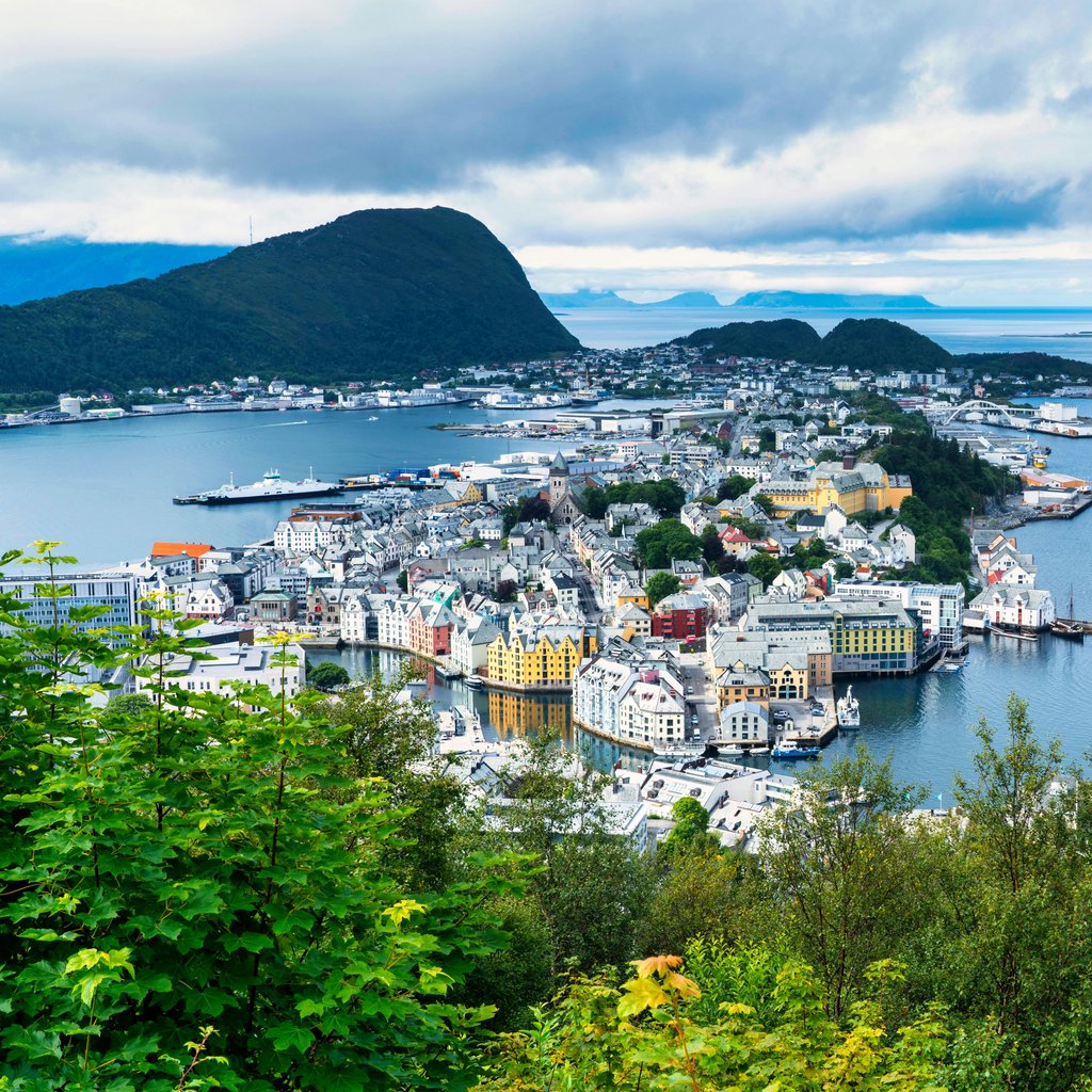 A breathtaking aerial view of Ålesund, Norway, showcasing its vibrant harbor and surrounding landscapes.