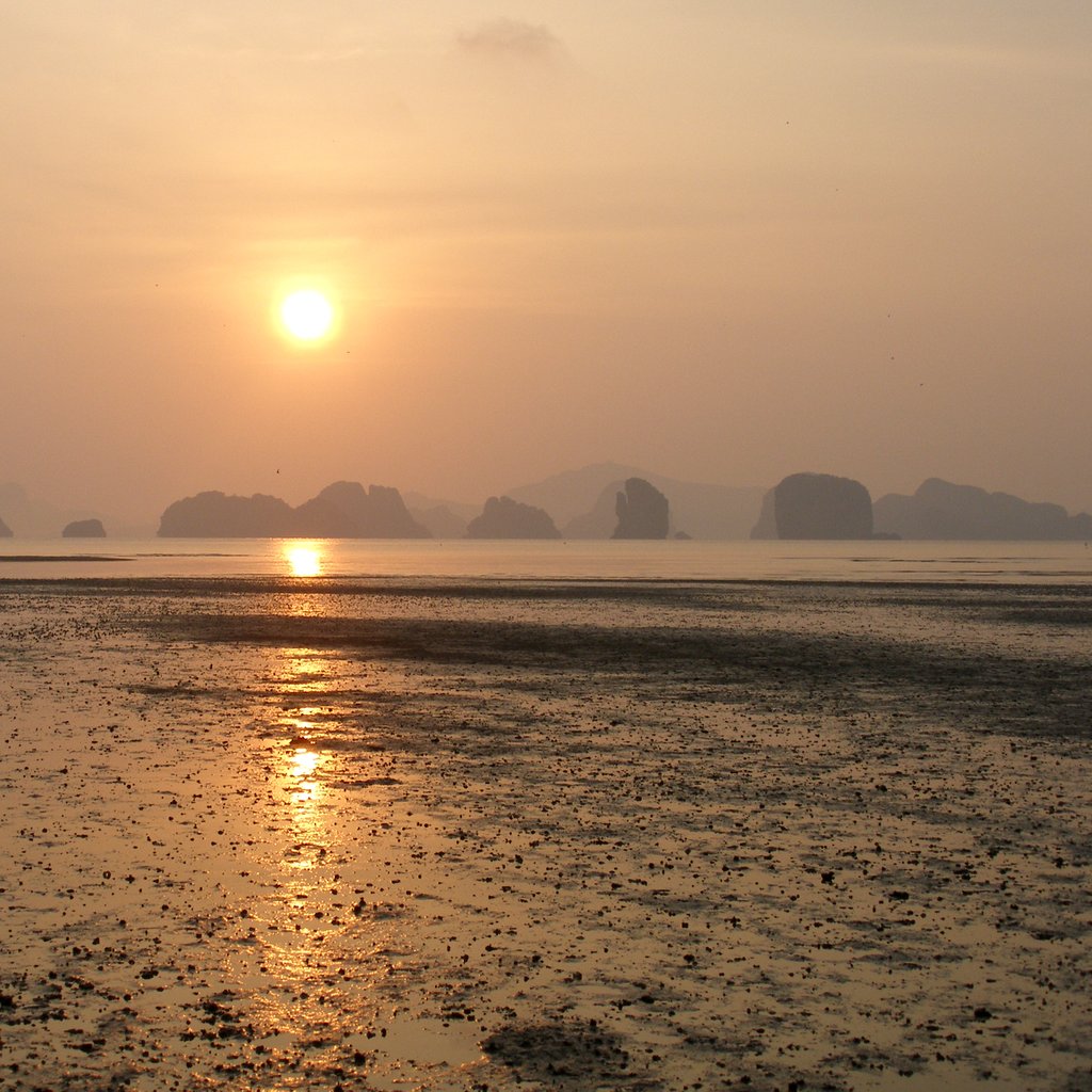 Dreamy ethereal sunrise on the shores of tropical Koh Yao Noi island. The islands of Krabi and Phang Nga Bay were formed by the movements of massive plates of Earth and lifted out of the seas. Koh Yao Noi (island), Phang Nga Bay, Thailand.